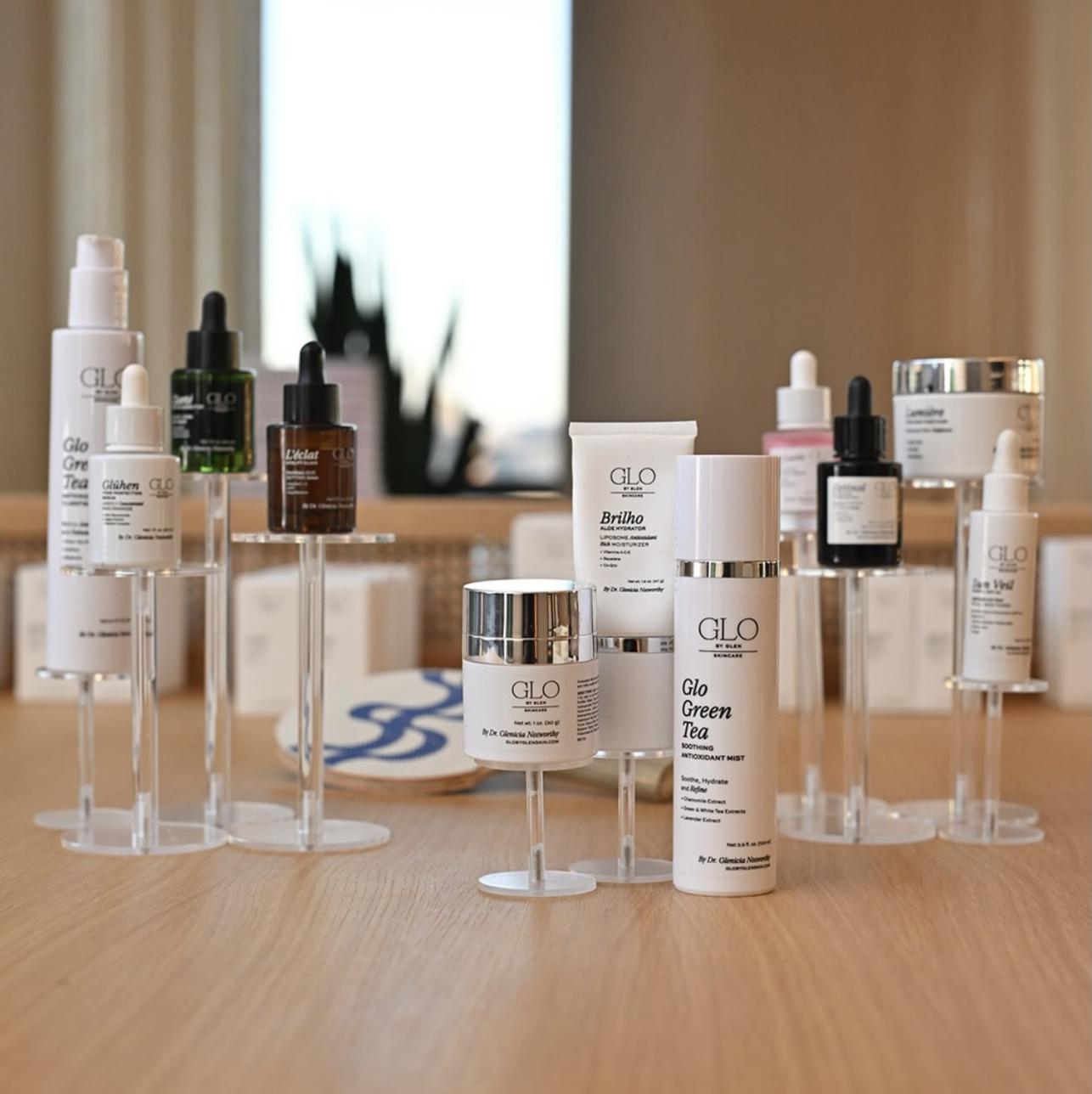 GLO by Glen skincare product display on acrylic stands