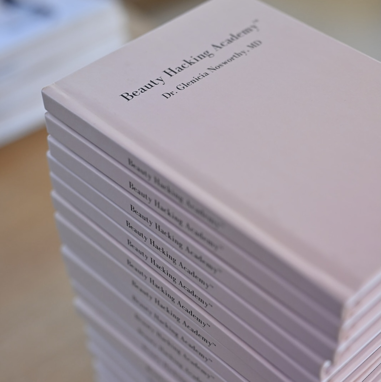 Stack of Beauty Hacking Academy books by Dr. Glenicia Nosworthy